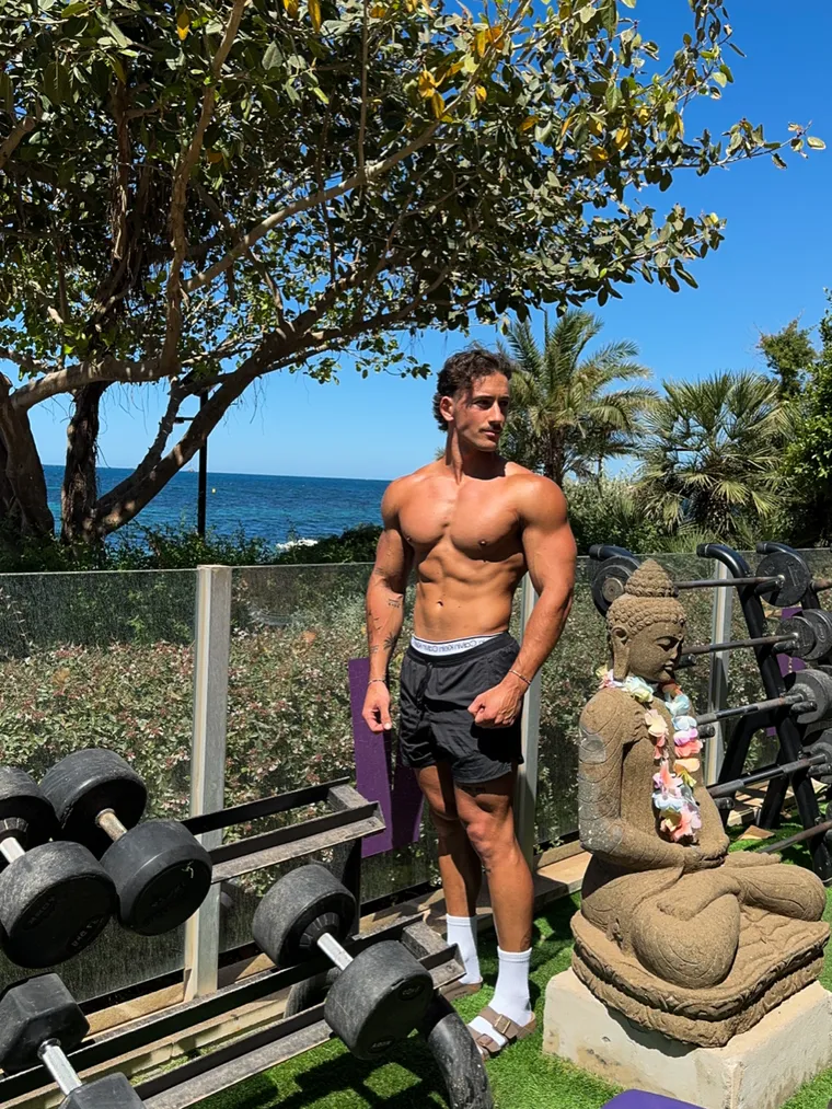 Coach Kalani showing built, conditioned muscle